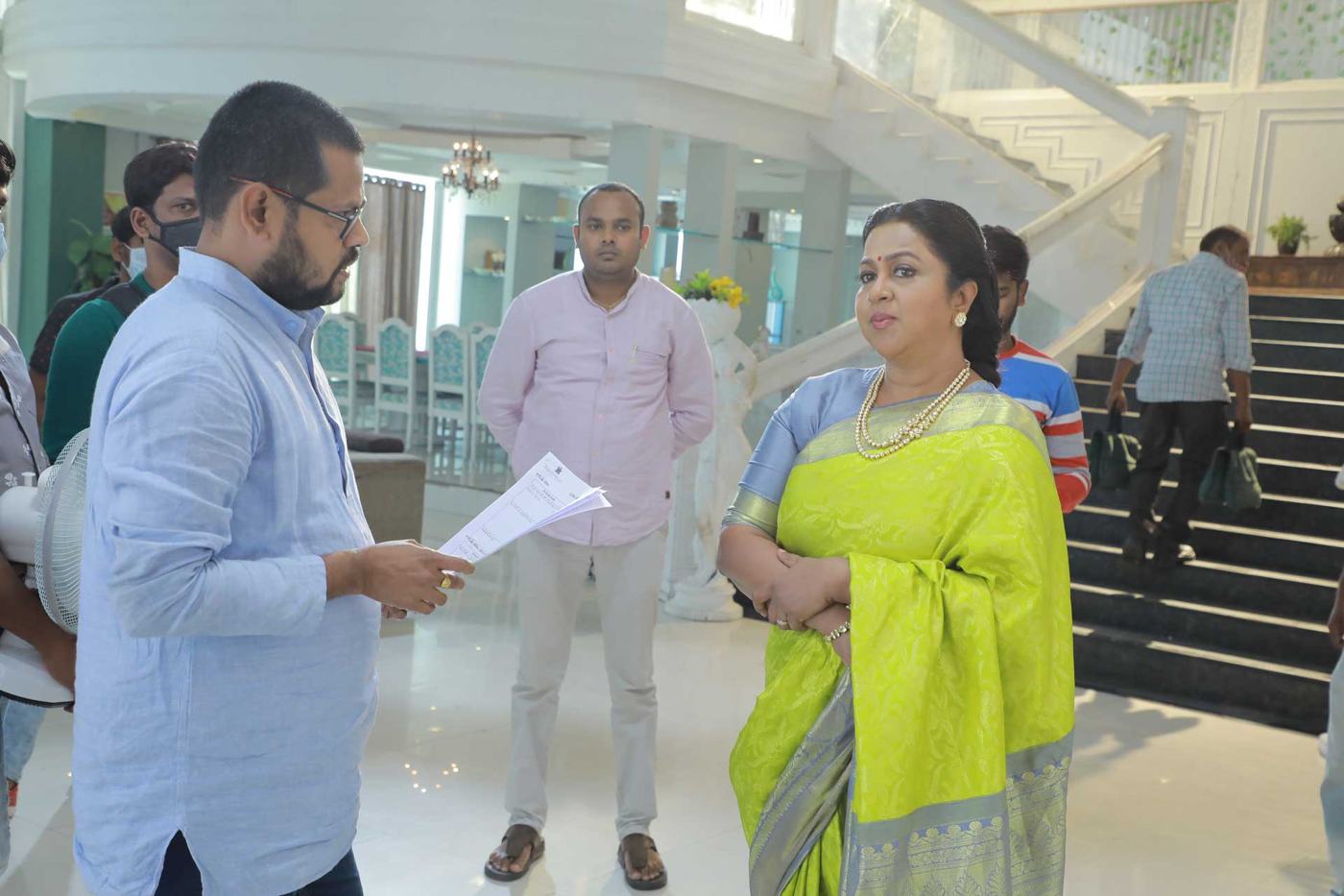 Director with a lead actress on a showroom set