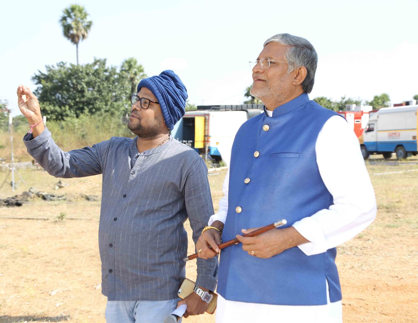 Director with a senior actor on an outdoor shoot